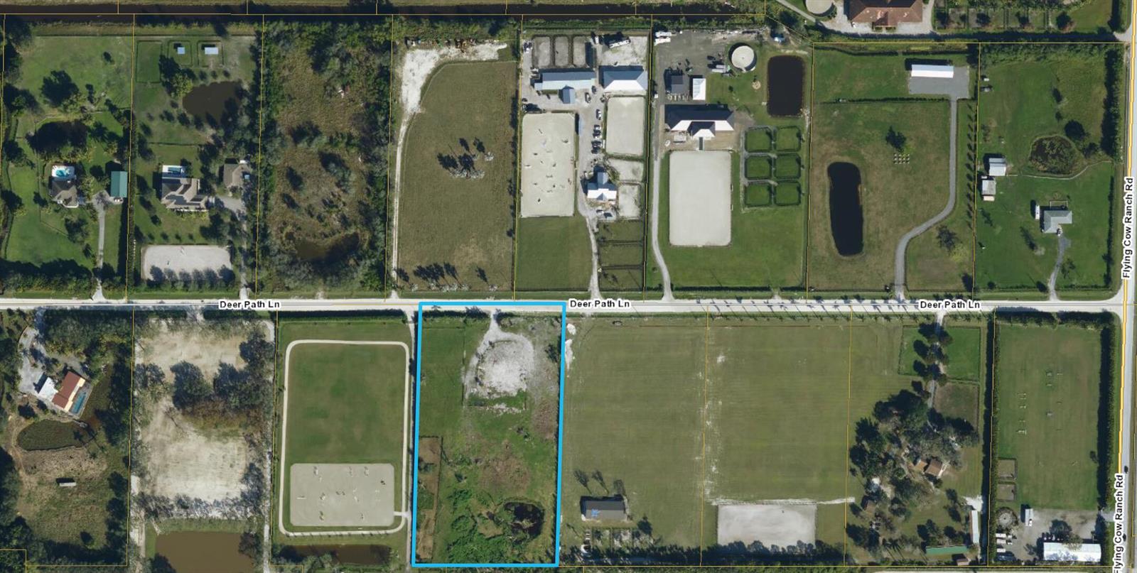 An aerial view shows a vacant rectangular lot bordered by roads and neighboring properties — 16296 Deer Path Lane, Wellington FL 33470, WELLINGTON, FL