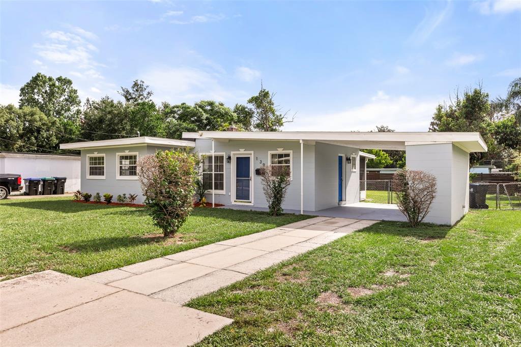 A single-story light gray house with a flat roof and an attached carport — 139 S ALDER DRIVE, ORLANDO, FL