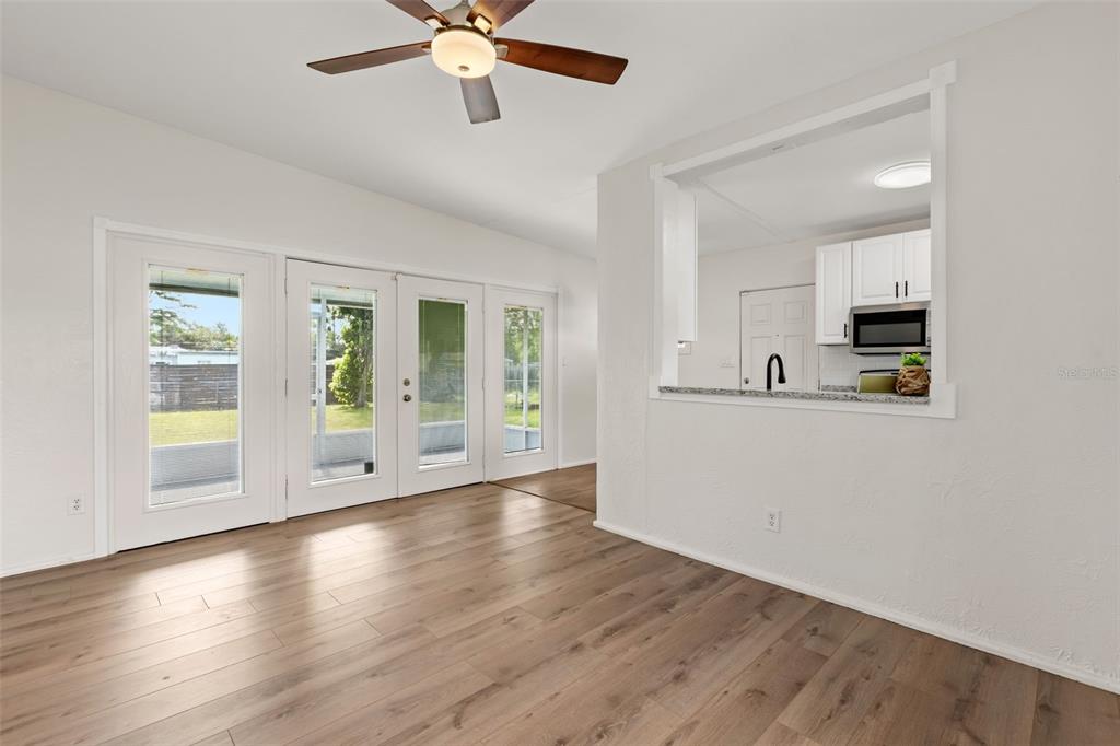 A living room features a sofa, two armchairs, a coffee table, and glass patio doors — 139 S ALDER DRIVE, ORLANDO, FL