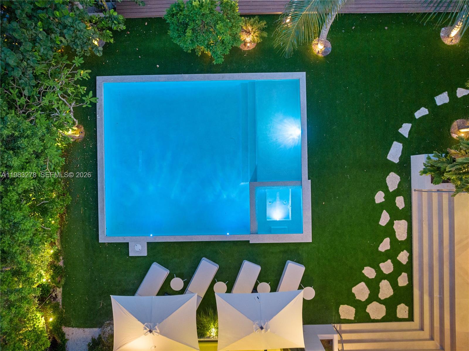 An aerial view shows a rectangular swimming pool with a spa set in a grassy yard — 1200 NE 87th St, Miami FL 33138, MIAMI, FL