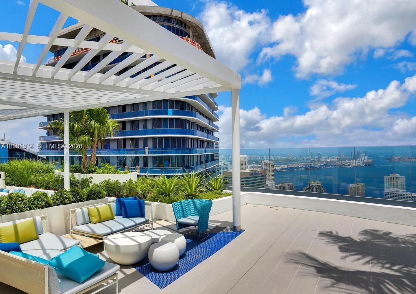 A rooftop terrace features outdoor seating, a white pergola, and panoramic views of the city — 45 SW 9th St # 3906, Miami FL 33130, MIAMI, FL