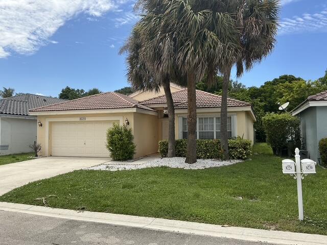 A single-story house with a beige exterior, a tiled roof, and a palm tree out front — 8229 White Rock Circle, Boynton Beach FL 33436, BOYNTON BEACH, FL