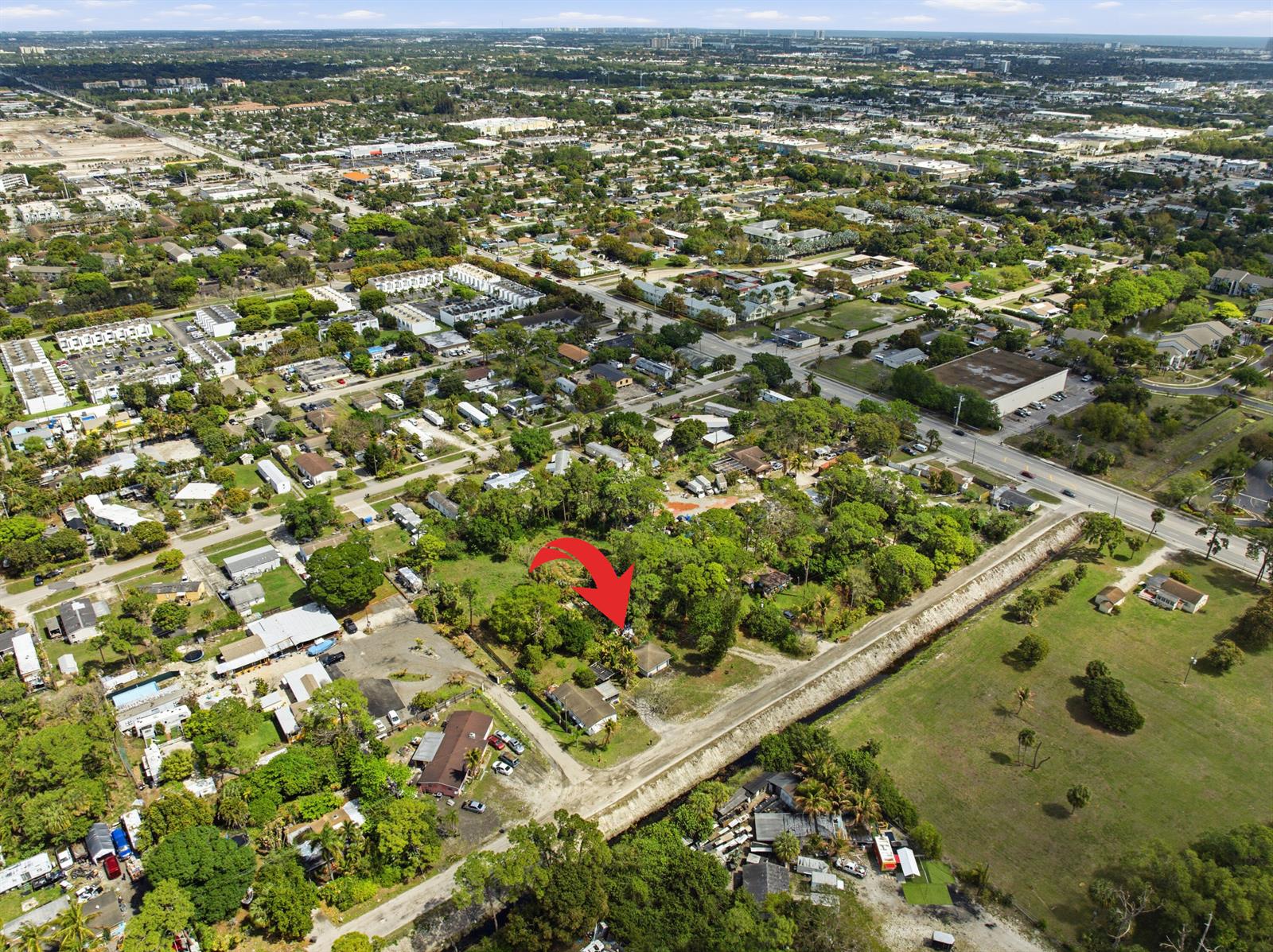 An aerial view shows a residential property with a house surrounded by trees and grass — 5133 Pine Grove Drive, West Palm Beach FL 33417, WEST PALM BEACH, FL