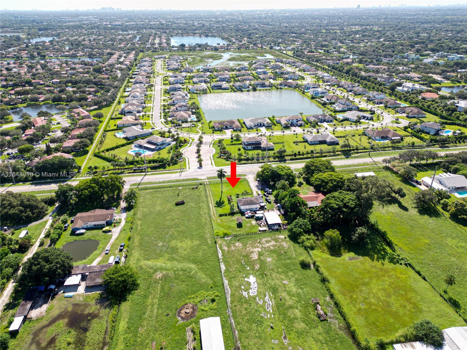 An aerial view shows a house with a red arrow pointing toward its property — 1921 SW 112th Ave, Davie FL 33325, DAVIE, FL