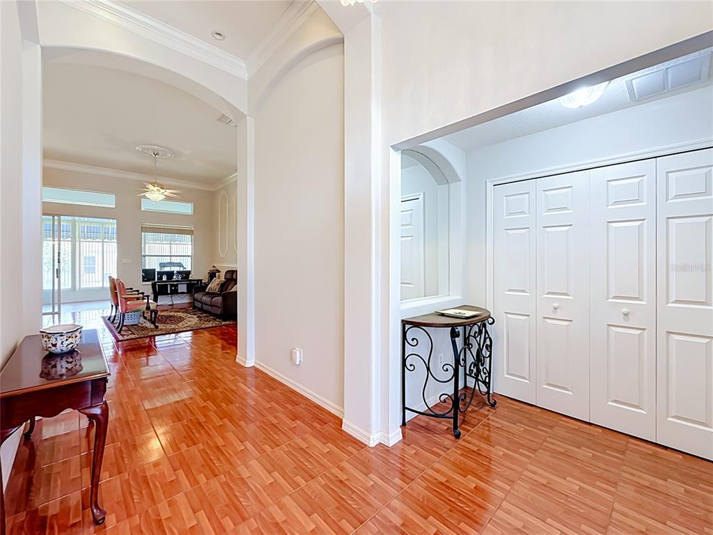 A tiled entryway leads into a living room with arched openings and white paneled doors — 24044 PEEKSKILL STREET, LEESBURG, FL
