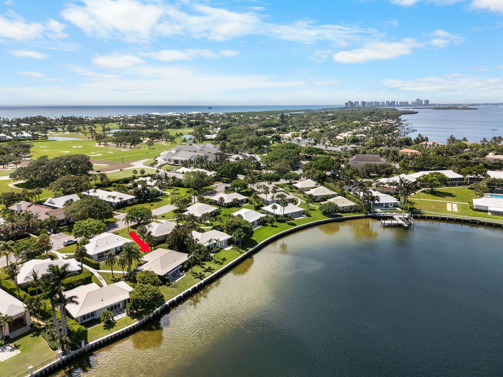 An aerial view shows a waterfront residential neighborhood with a red arrow pointing to a house — 11639 Lost Tree Way # 22, North Palm Beach FL 33408, NORTH PALM BEACH, FL