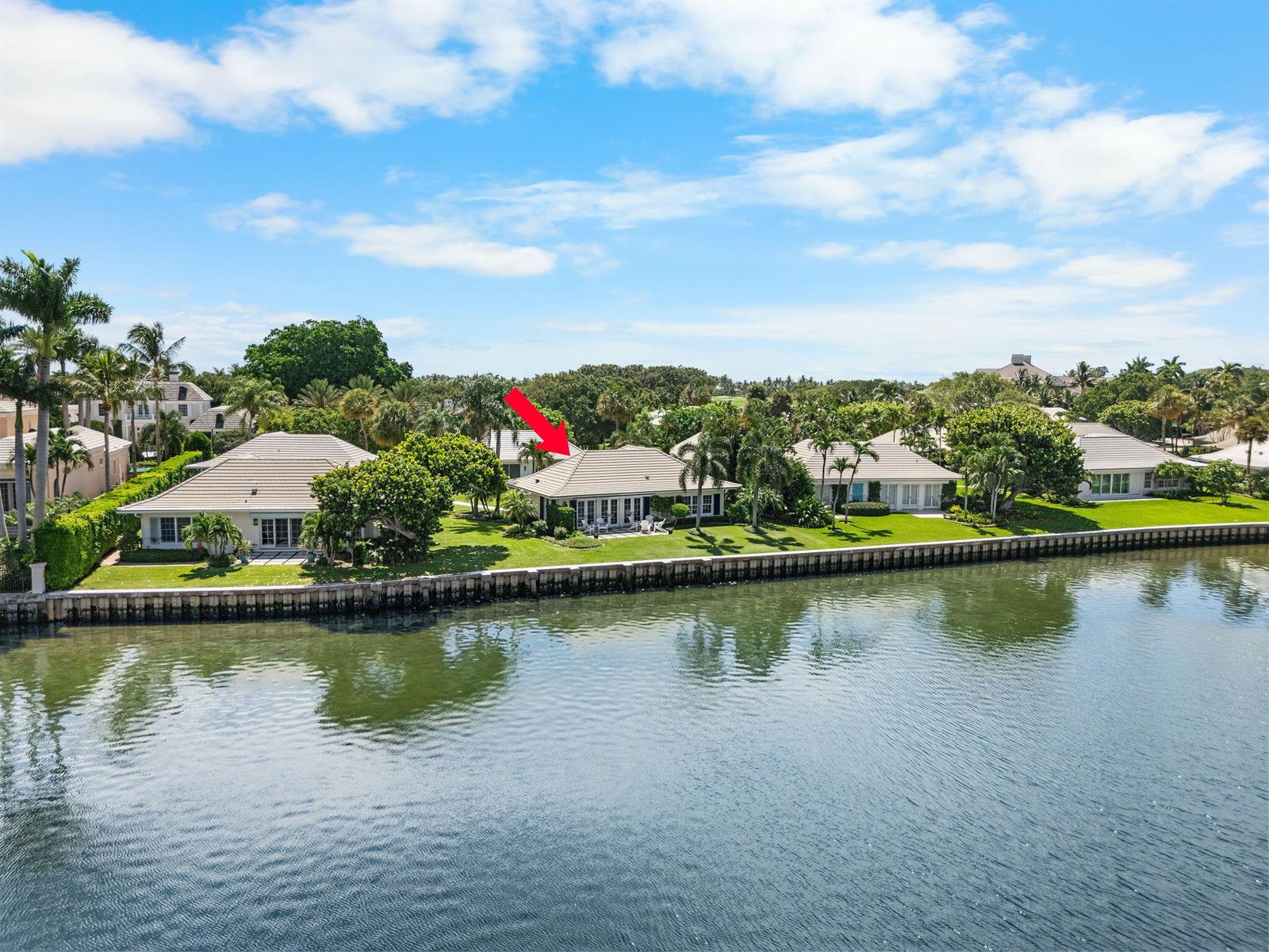 An aerial view shows several waterfront houses with tiled roofs along a canal — 11639 Lost Tree Way # 22, North Palm Beach FL 33408, NORTH PALM BEACH, FL