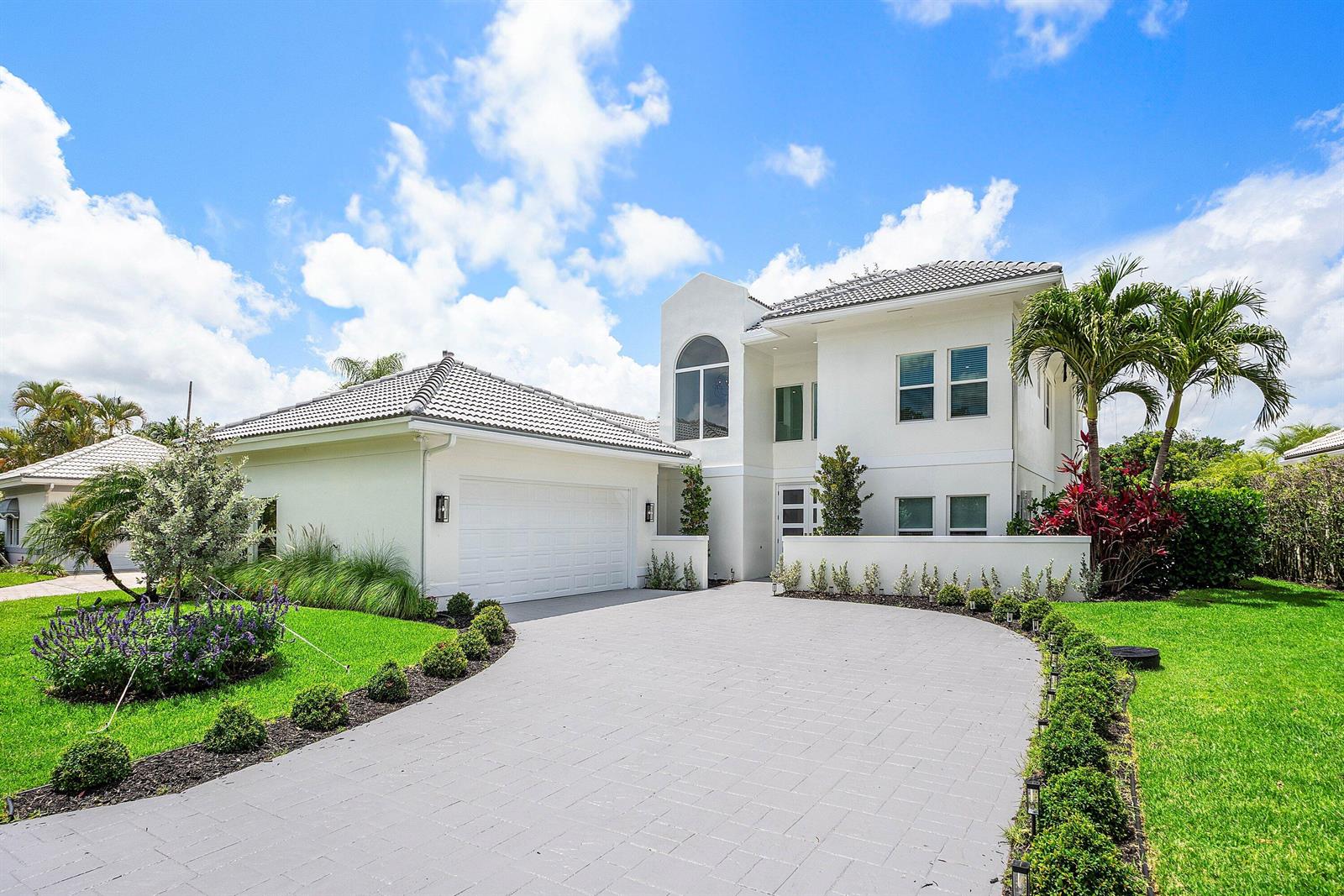 A two-story white house with a gray tile roof and a curved paved driveway — 9701 Spray Drive, West Palm Beach FL 33411, WEST PALM BEACH, FL