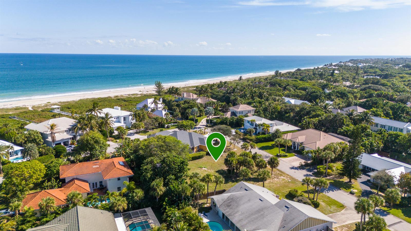 An aerial view shows a coastal neighborhood with a green location pin on a property — 1370 White Heron Lane, Vero Beach FL 32963, VERO BEACH, FL
