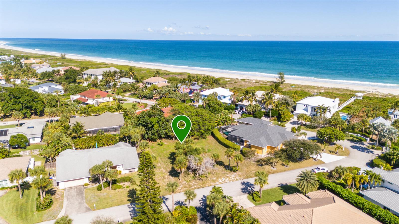 An aerial view shows a vacant, tree-filled lot situated in a coastal residential neighborhood — 1370 White Heron Lane, Vero Beach FL 32963, VERO BEACH, FL