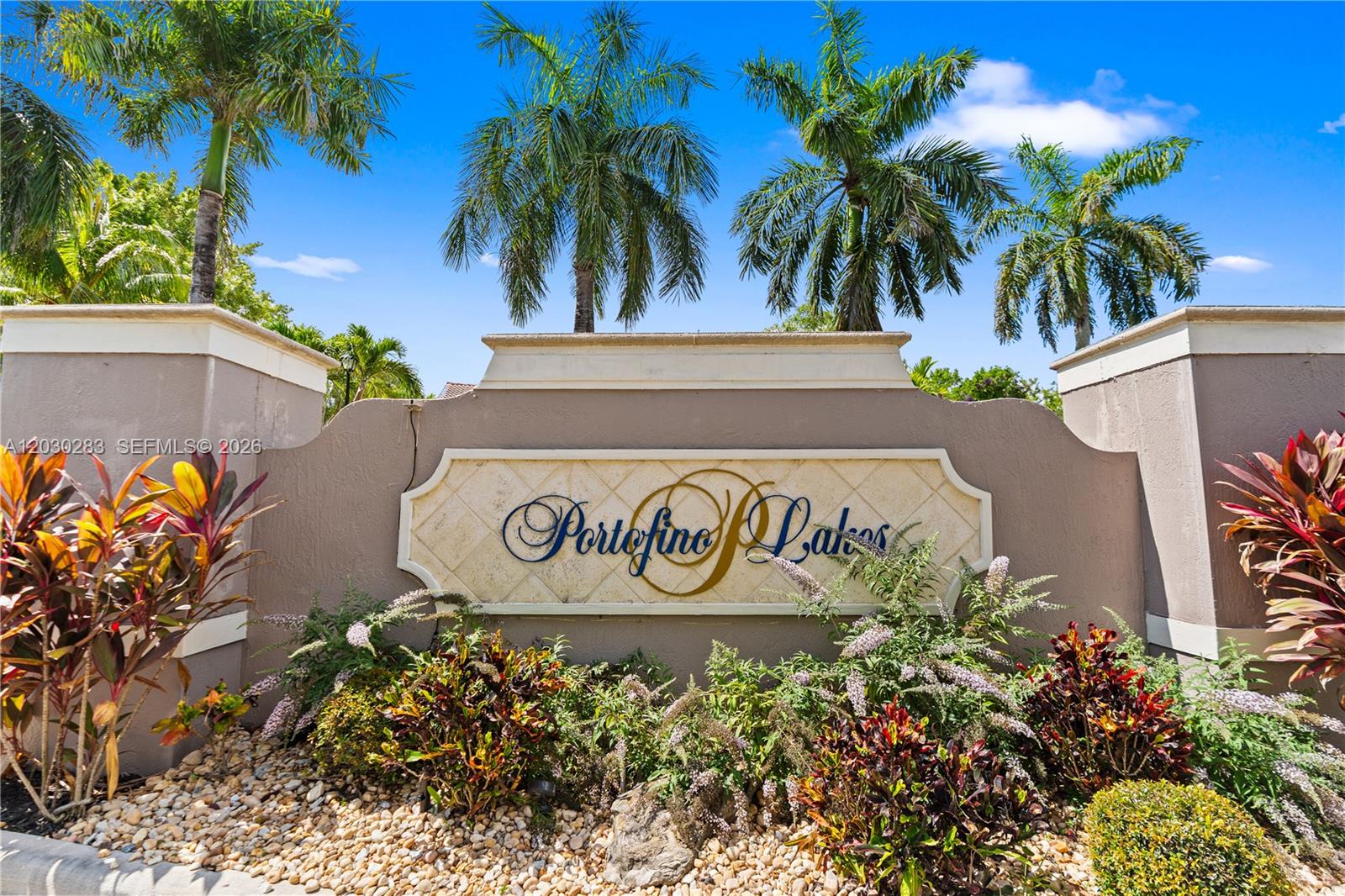 A stone sign for Portofino Lakes stands surrounded by palm trees and landscaping — 1785 NE 37th Pl, Homestead FL 33033, HOMESTEAD, FL