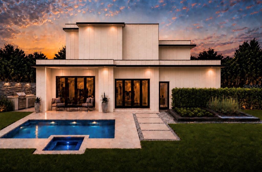 A modern two-story house with a pool, spa, and patio at sunset — 2228 HOWARD DRIVE, WINTER PARK, FL