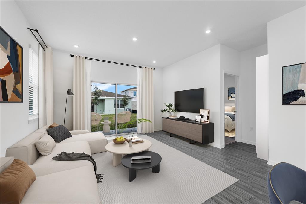 This is a digital rendering of a modern living room with a sectional and patio — 4462 RIVER BEACON BOULEVARD, DAVENPORT, FL