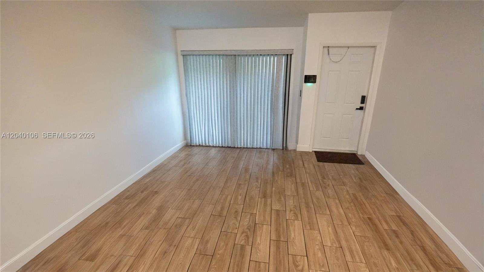 This living room features a gray sectional sofa, a marble coffee table, and wood flooring — 2566 N Nob Hill Rd, Sunrise FL 33322, SUNRISE, FL