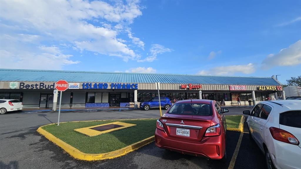 A strip mall features several storefronts with a parking lot in the foreground — 100 PR-100 KM 7.2 INT. PR-102, CABO ROJO, PR