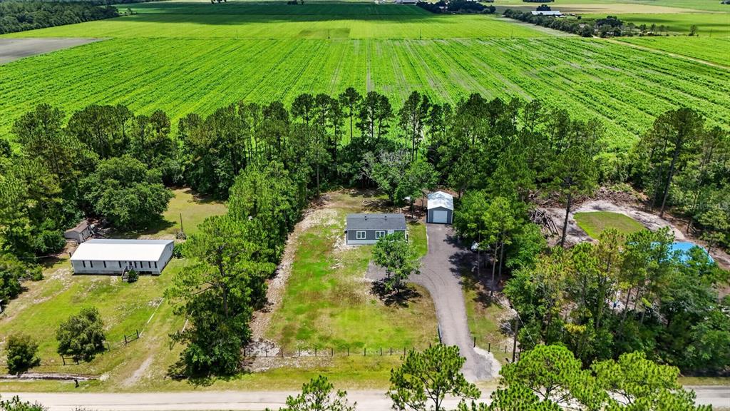 An aerial view shows a house, a detached garage, and a shed on a rural lot — 4825 PECAN AVENUE, BUNNELL, FL