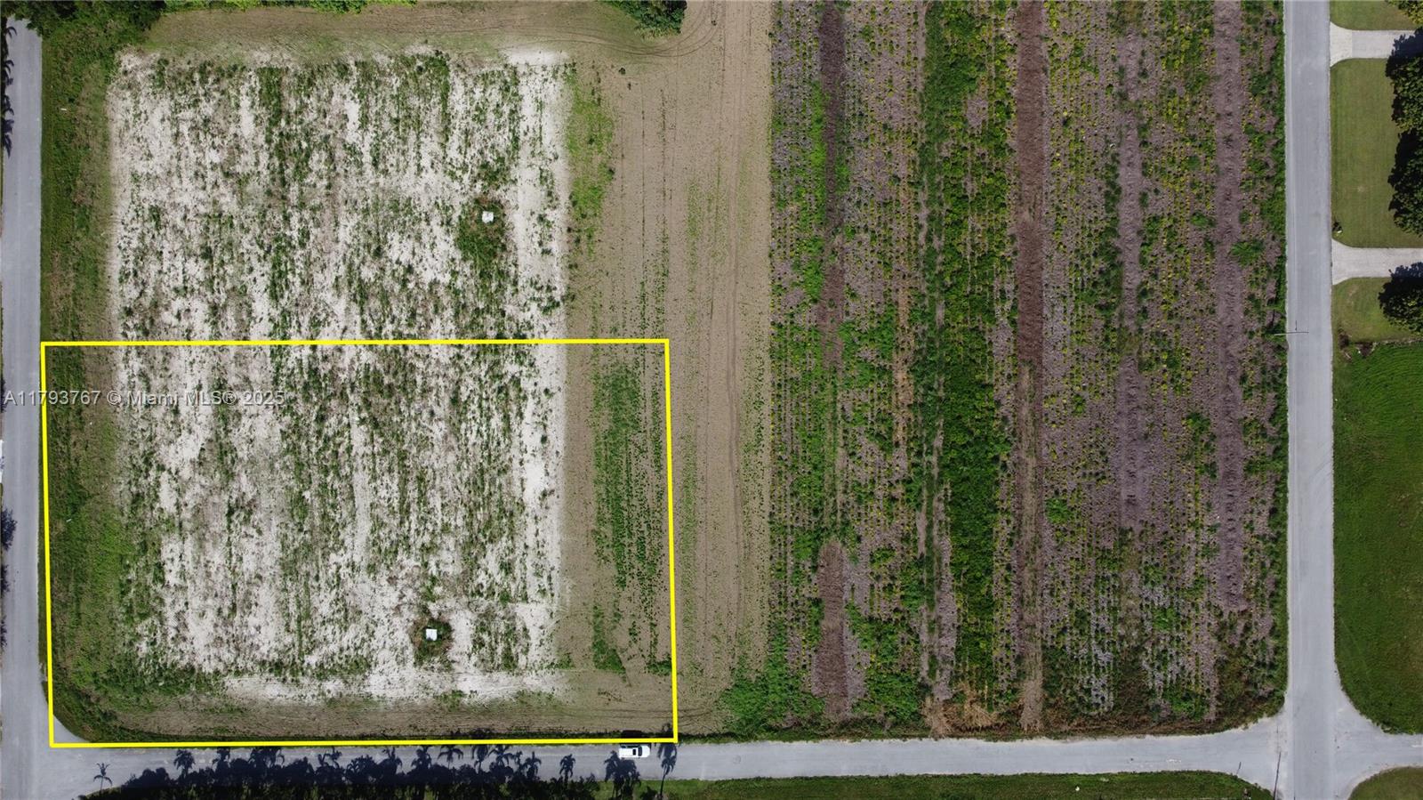 An aerial view shows a rectangular plot of land outlined in yellow near a road — 21298 SW 238th ST, Miami FL 33031, MIAMI, FL