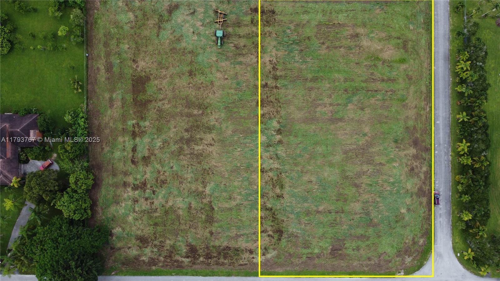 An aerial view shows a cleared, rectangular plot of land bordered by yellow lines — 21298 SW 238th ST, Miami FL 33031, MIAMI, FL