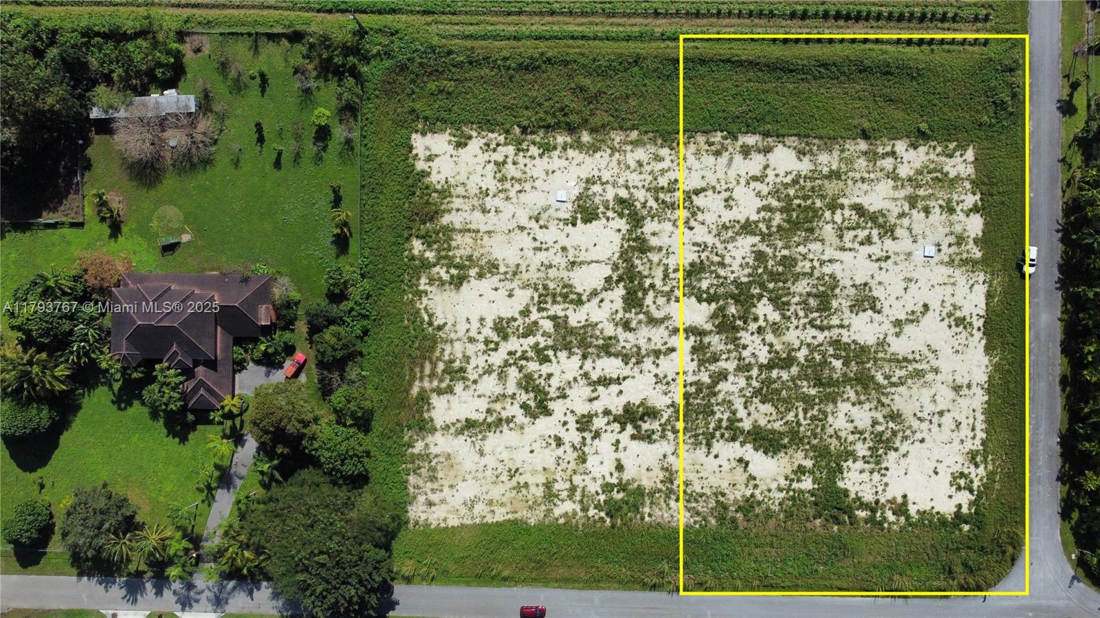 An aerial view shows a vacant, rectangular lot outlined in yellow next to a house — 21298 SW 238th ST, Miami FL 33031, MIAMI, FL