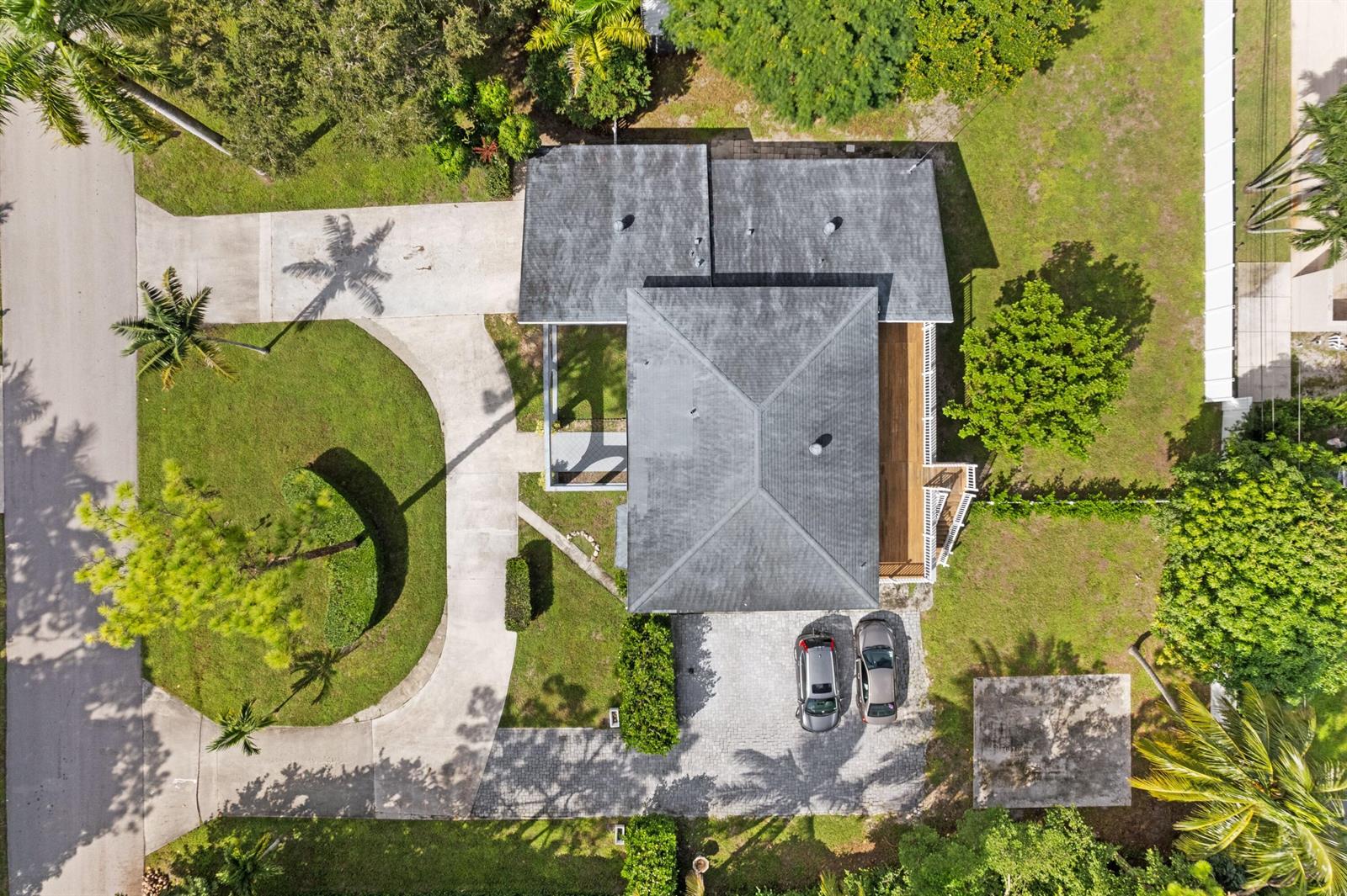 An aerial view shows a house with a gray roof, two driveways, and surrounding landscaping — 5285 Sunrise Boulevard, Delray Beach FL 33484, DELRAY BEACH, FL