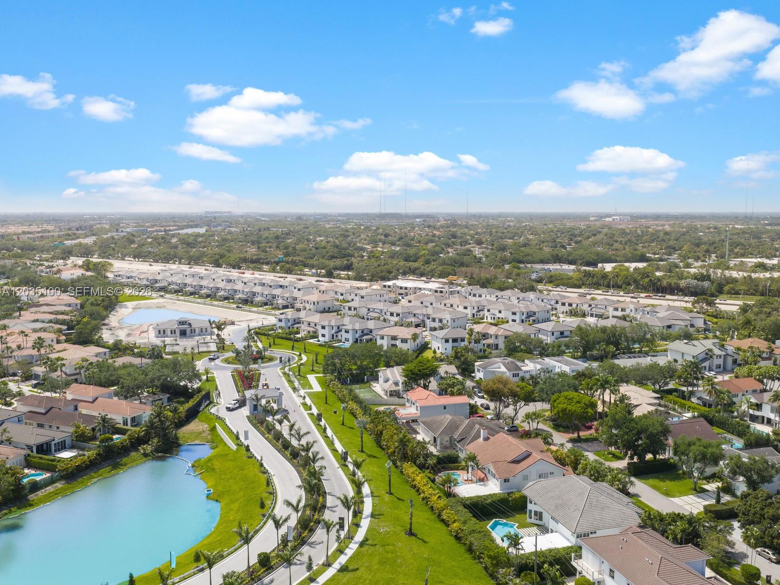 An aerial view shows a suburban residential neighborhood with houses, a lake, and roads — 19701 NE 16th Pl, Miami FL 33179, MIAMI, FL