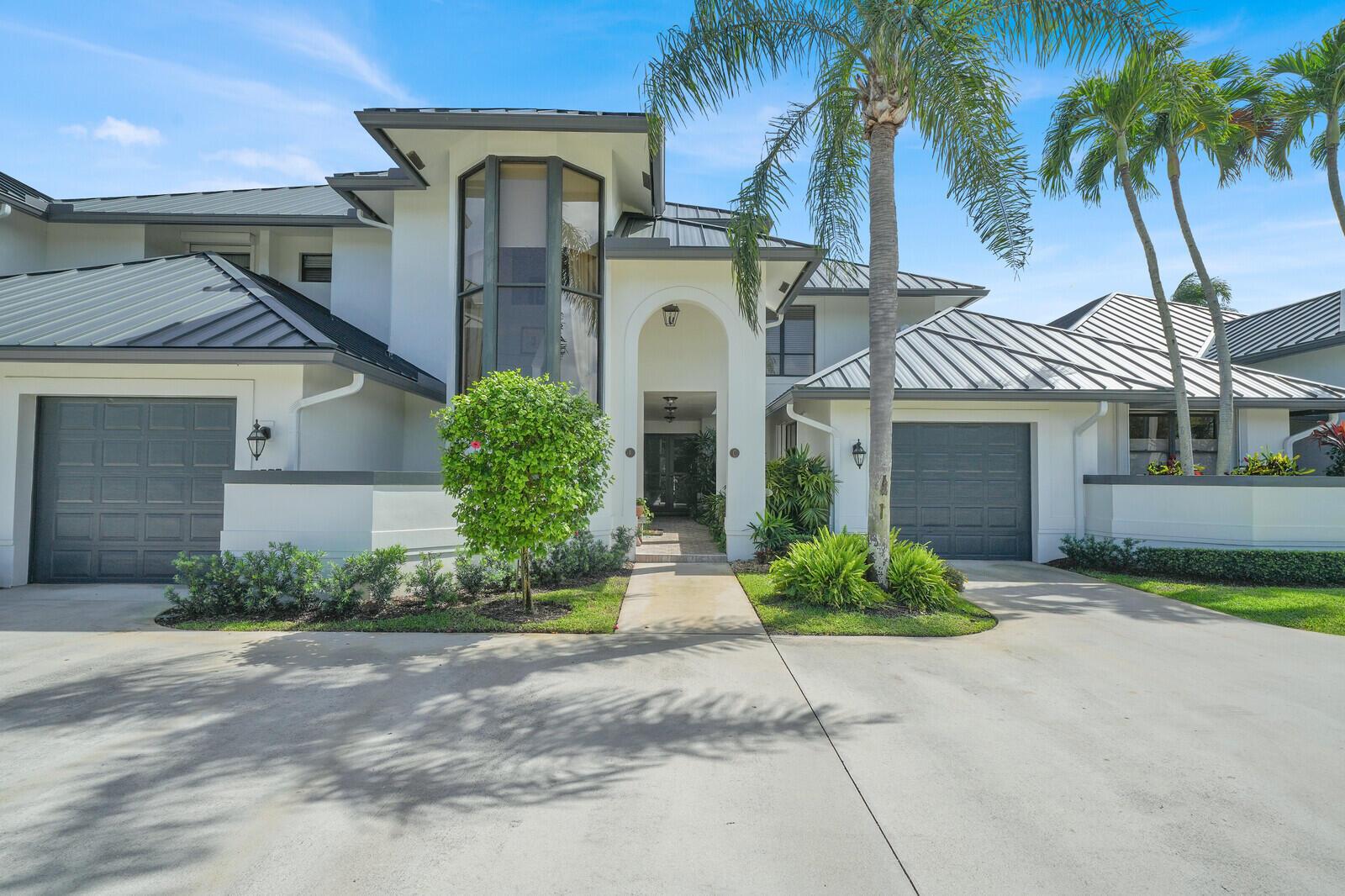 An aerial view of a large, multi-car garage estate with a metal roof near water — 181 Atlantis Boulevard # C, Atlantis FL 33462, ATLANTIS, FL