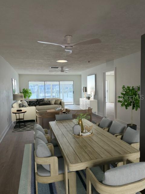 This open-concept living and dining room features light wood floors and a view of water — 582 BOCA CIEGA POINT BOULEVARD N, ST PETERSBURG, FL