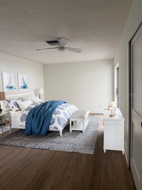 A bedroom features a bed with blue bedding, a ceiling fan, and a white dresser — 582 BOCA CIEGA POINT BOULEVARD N, ST PETERSBURG, FL