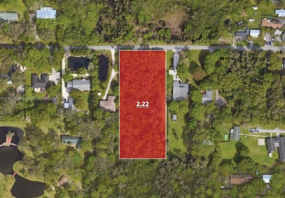 This aerial map shows a rectangular, wooded parcel of land highlighted in red — 2101 Dade Rd, Fort Pierce FL 34982, FORT PIERCE, FL