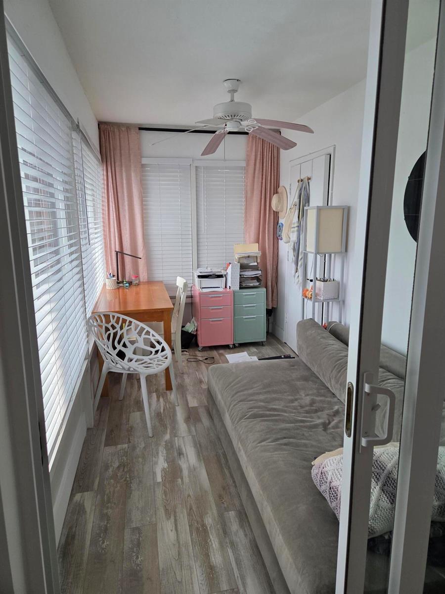 A small home office and lounge area features a wooden desk, two colorful filing cabinets, and a sofa — BOYNTON BEACH, FL