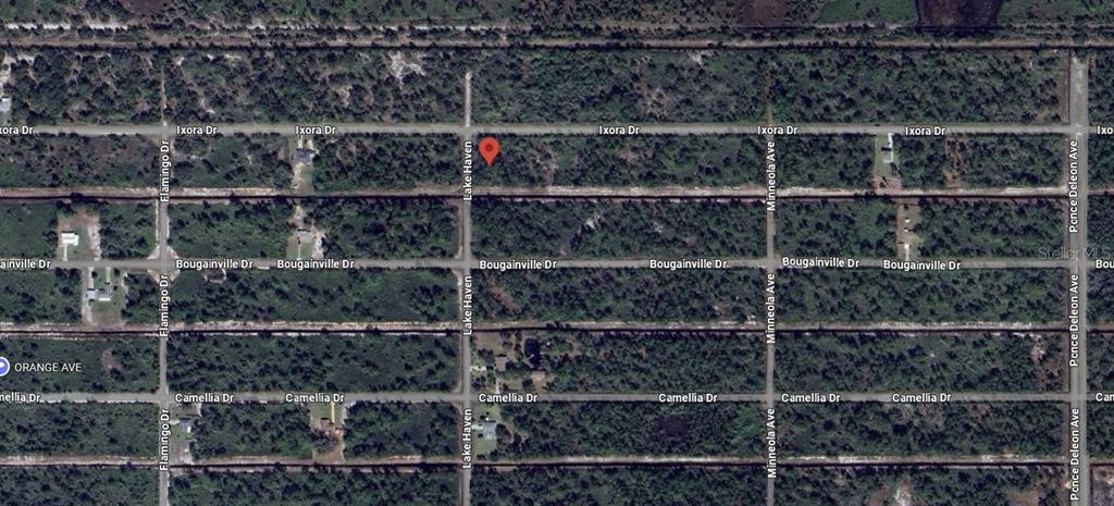 This aerial map shows a vacant, wooded residential lot marked with a red pin — 408 AZALEA DRIVE, INDIAN LAKE ESTATES, FL