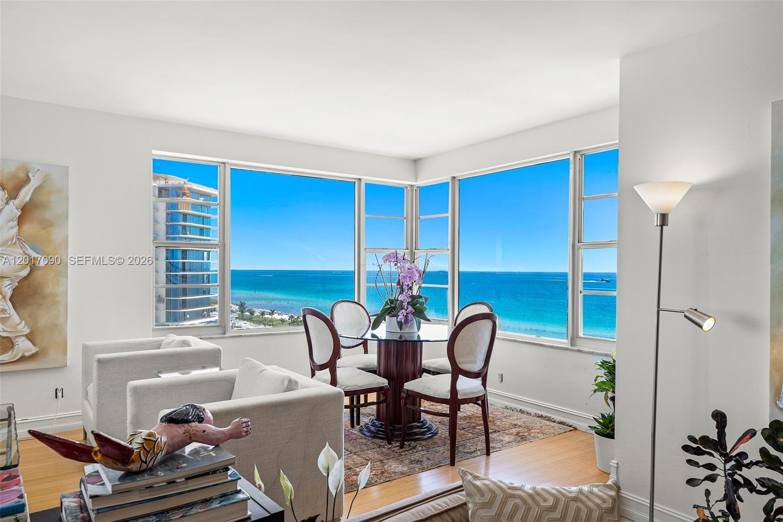 A dining area with a glass table and ocean views through floor-to-ceiling windows — 5255 Collins Ave # 9F, Miami Beach FL 33140, MIAMI BEACH, FL
