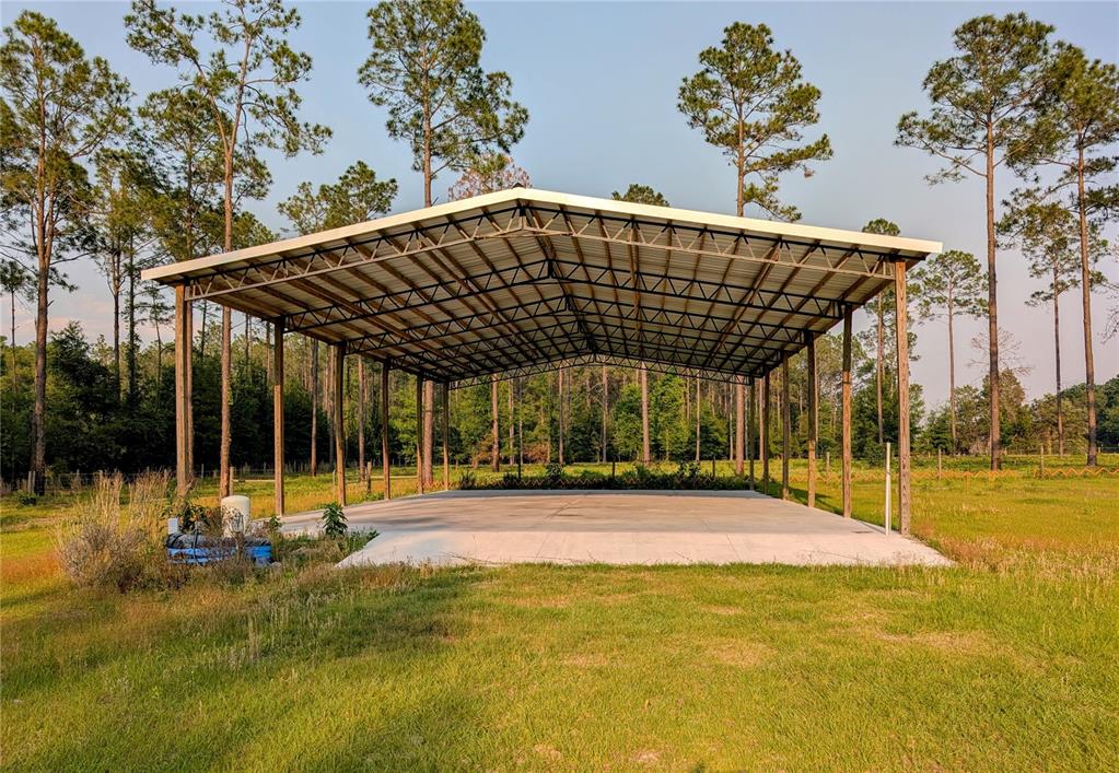 An aerial view shows a large rural property with open fields, scattered trees, and outbuildings — 14421 NW 214TH TERRACE, HIGH SPRINGS, FL