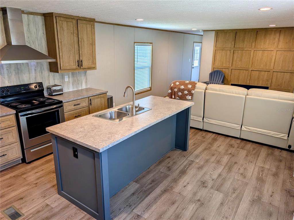 A single-story manufactured home sits on a large grassy lot with a detached metal carport — 14421 NW 214TH TERRACE, HIGH SPRINGS, FL