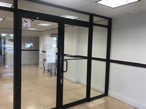 A glass-paneled door with a black frame leads into a tiled office lobby — 4174 Inverrary Drive # 907, Lauderhill FL 33319, LAUDERHILL, FL