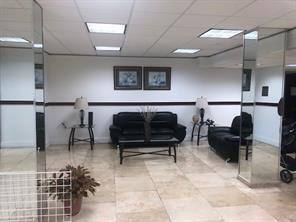 A waiting area features black leather furniture, tiled floors, and mirrored columns — 4174 Inverrary Drive # 907, Lauderhill FL 33319, LAUDERHILL, FL