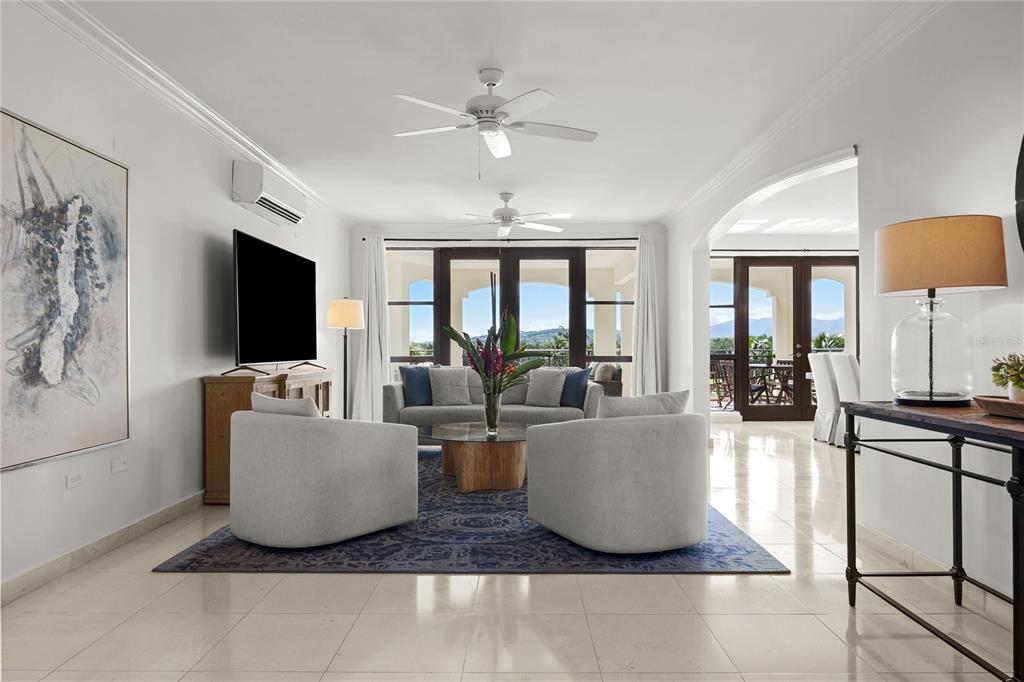 A living room features light tile floors, two armchairs, a sofa, and a large rug — 400 COCO BEACH BVL UNIT 302B, RIO GRANDE, PR