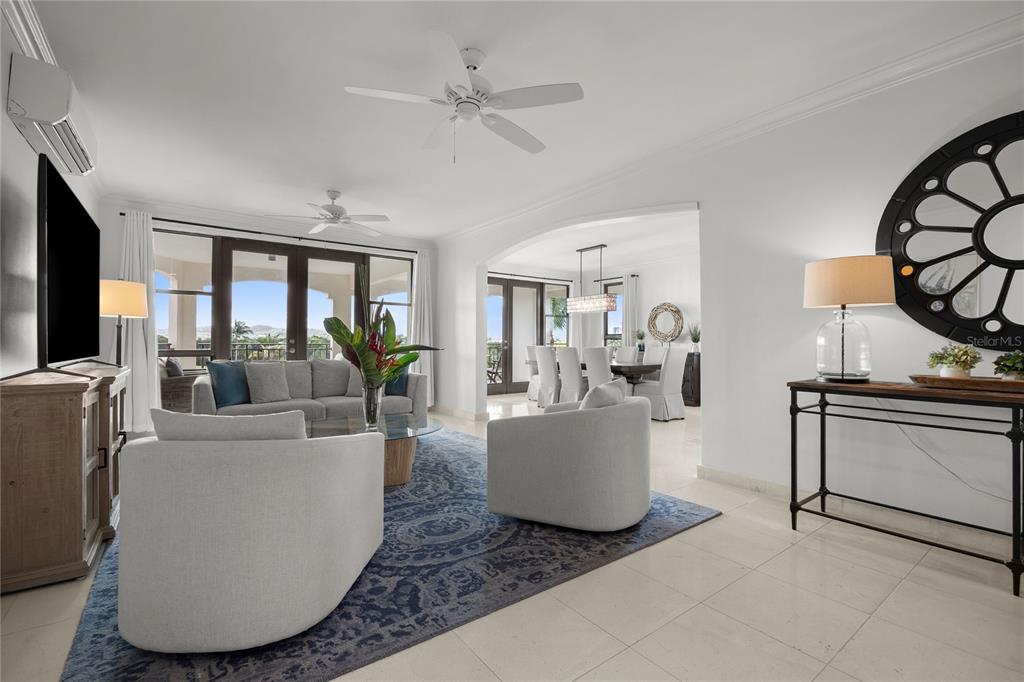 A living room with light furniture, a blue patterned rug, and an adjacent dining area — 400 COCO BEACH BVL UNIT 302B, RIO GRANDE, PR