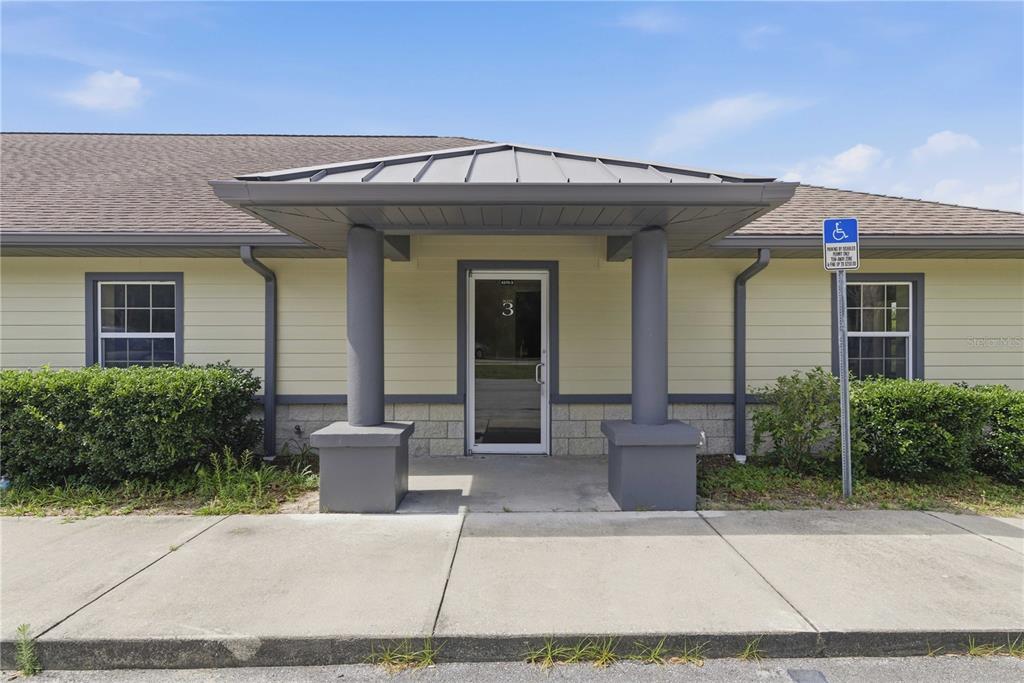 The exterior of a single-story commercial building features a covered entrance with two gray pillars — 4370 NE 35TH STREET UNIT 3, OCALA, FL
