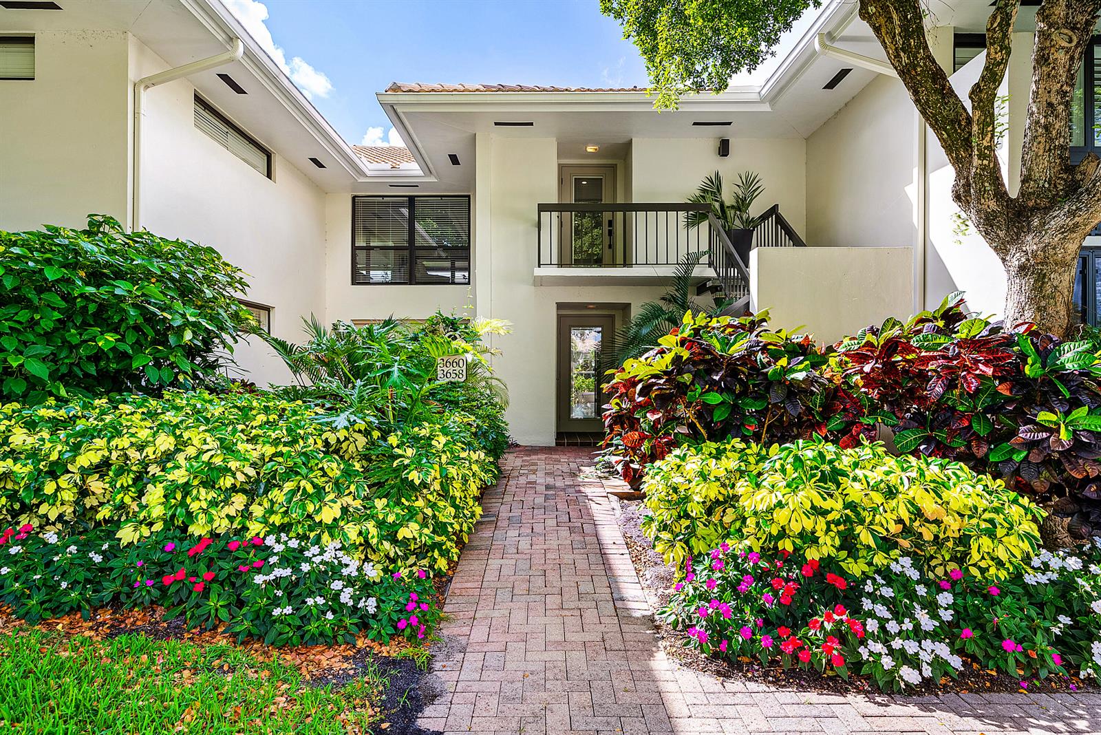 A brick walkway leads to the entrance of a two-story building surrounded by lush landscaping — 3660 N Quail Ridge Dr Drive, Boynton Beach FL 33436, BOYNTON BEACH, FL