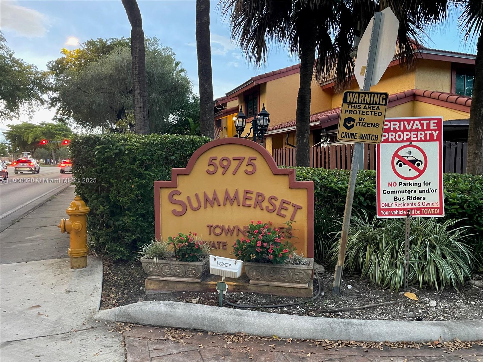 A sign for Summerset Townhomes stands near a sidewalk, a fire hydrant, and warning signs — 5975 SW 137th Ave # 702, Miami FL 33183, MIAMI, FL