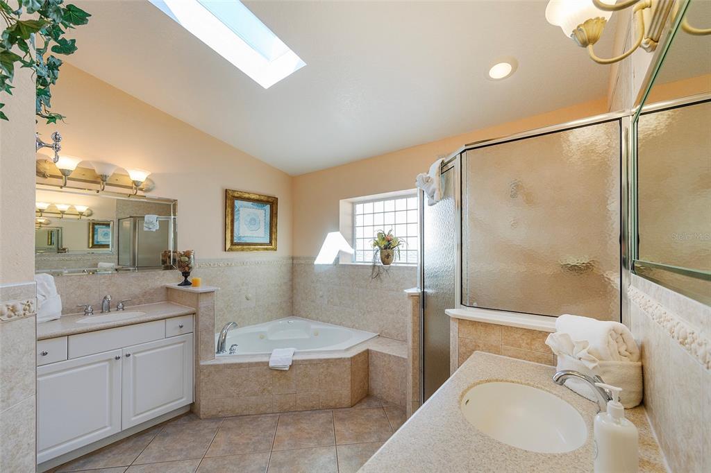 A yellow front door and bench sit on a paved patio with a metal gate — 3837-3839 S ATLANTIC AVENUE, DAYTONA BEACH, FL