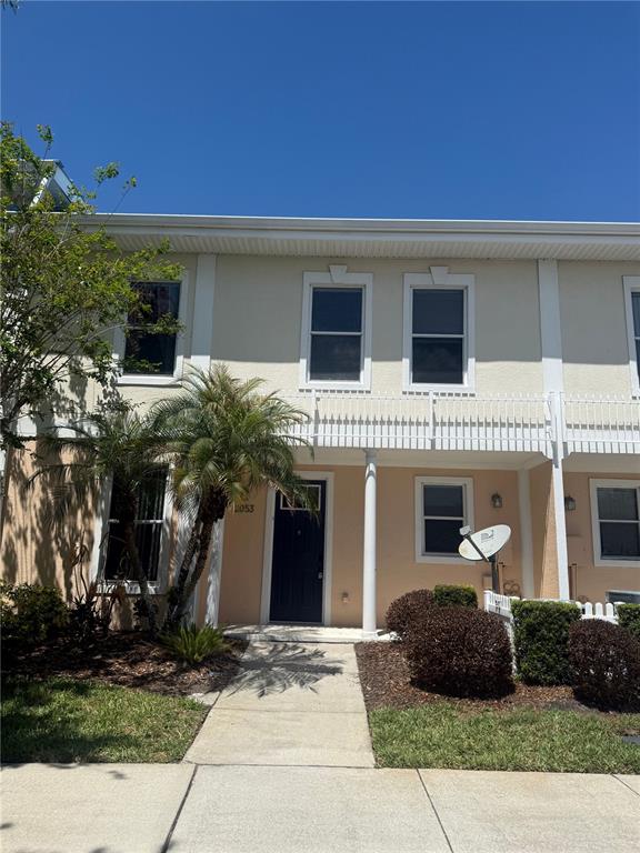 A kitchen with white cabinets, a central island, and tile flooring in an open space — 2053 GREEN OAK COURT, KISSIMMEE, FL