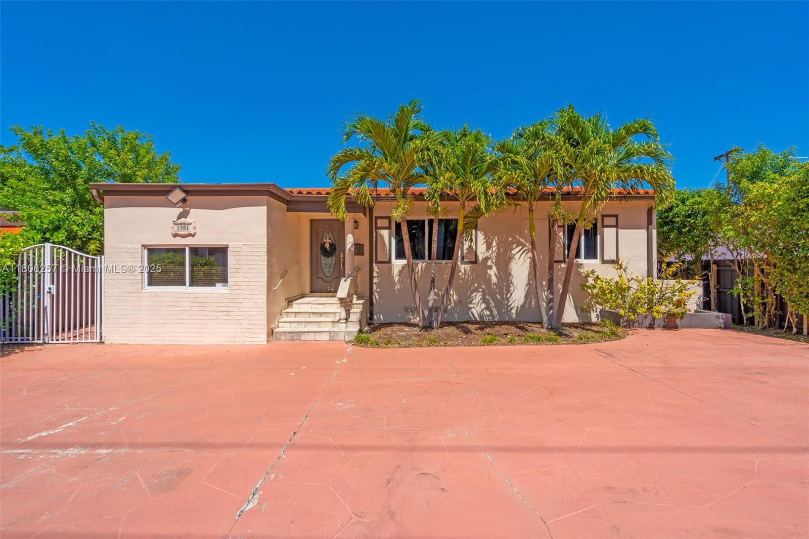 A single-story house with a red concrete driveway, palm trees, and a front entrance — 1901 SW 37th Ave, Miami FL 33145, MIAMI, FL