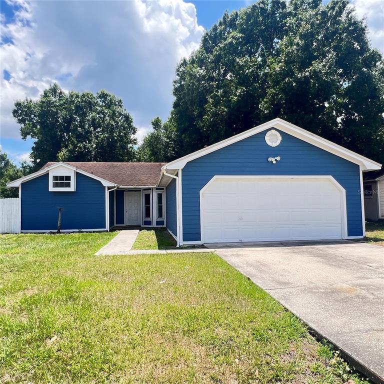 A blue, single-story house with a two-car garage and a concrete driveway — 3430 FOX RIDGE STREET, WINTER HAVEN, FL
