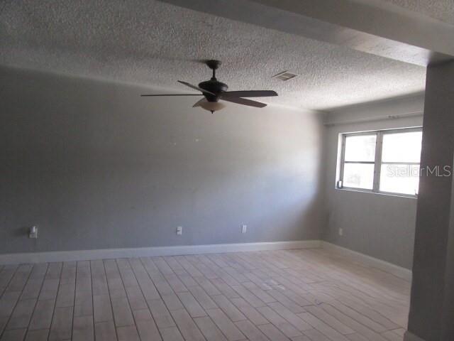 A single-story gray house with a concrete driveway and a white front door — 381 69TH STREET N, CLEARWATER, FL