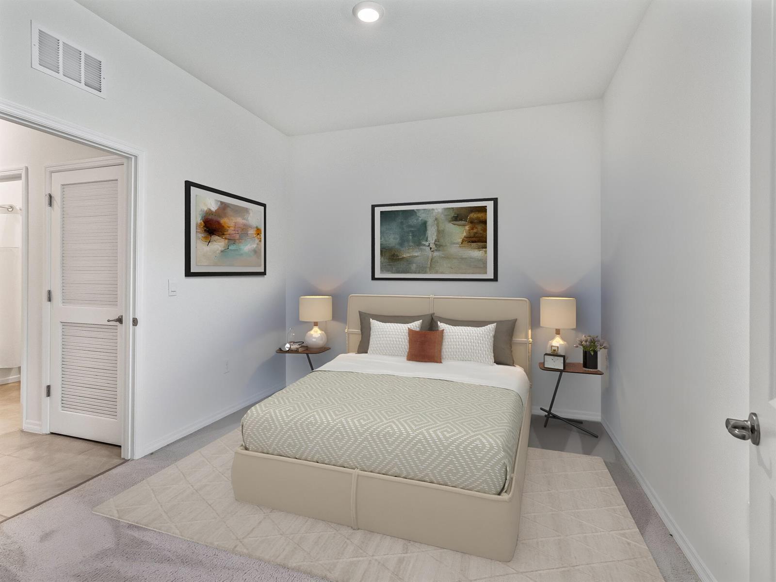 A bedroom features a beige upholstered bed, two side tables with lamps, and wall art — 5536 NW 40th Loop, Ocala FL 34482, OCALA, FL