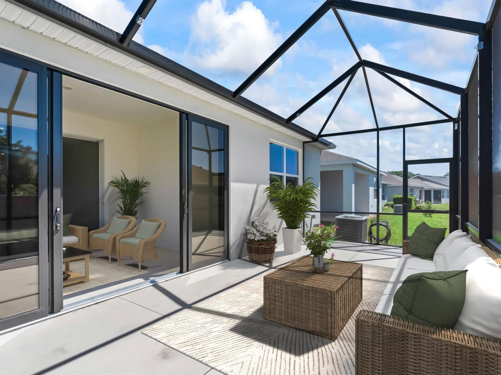 A screened-in patio features a concrete floor, wicker furniture, and sliding glass doors to indoors — 5536 NW 40th Loop, Ocala FL 34482, OCALA, FL