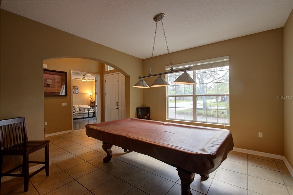 A tiled entryway features double front doors, a high ceiling, and an adjacent game room — 2516 WOODSIDE RIDGE DRIVE, APOPKA, FL