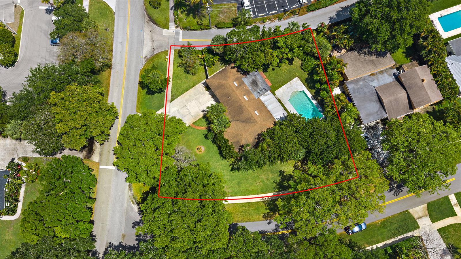An aerial view shows a house with a pool and large trees on a lot — 844 Anchorage Drive, North Palm Beach FL 33408, NORTH PALM BEACH, FL
